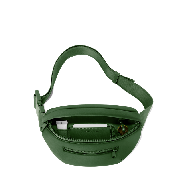 Dagne Dover Ace Fanny Pack in a rich, classic forest green unzipped, exposing the interior pockets. hover