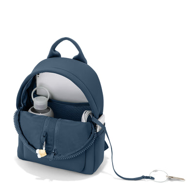 Dagne Dover small Dakota Neoprene Backpack in moonlight blue unzipped, revealing the interior air mesh pockets. hover