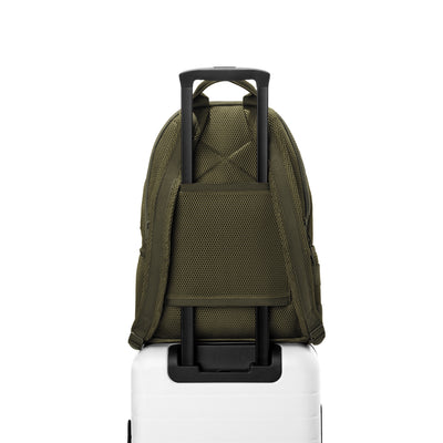 Dagne Dover large Dakota airmesh Backpack in dark green strapped to luggage with the airmesh luggage-handle sleeve.