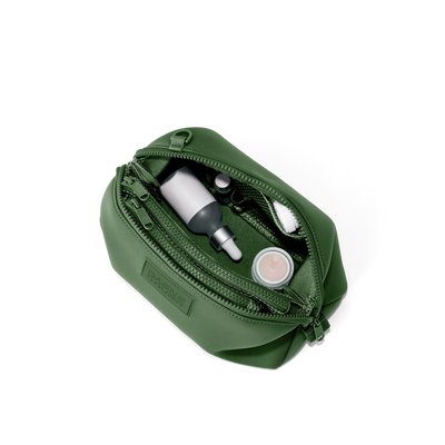 Dagne Dover Large Hunter Toiletry Bag in a rich, classic forest green unzipped and seen from above.
