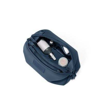 Dagne Dover Large Hunter Toiletry Bag in moonlight blue unzipped and seen from above.