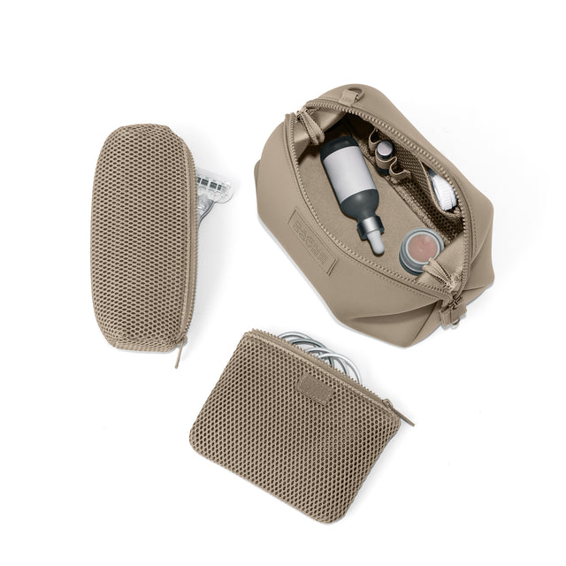 Dagne Dover Large Hunter Toiletry Bag in khaki unzipped and seen from above with the removable air mesh pouch alongside it. hover