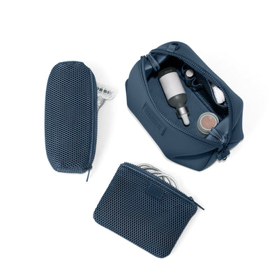 Dagne Dover Large Hunter Toiletry Bag in moonlight blue unzipped and seen from above with the removable air mesh pouch alongside it. hover