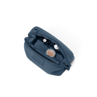 Dagne Dover Small Hunter Toiletry Bag in moonlight blue unzipped and seen from above.