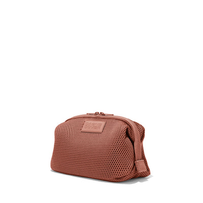 Dagne Dover Large Hunter Toiletry Bag in warm dust pink air mesh seen from an angle.