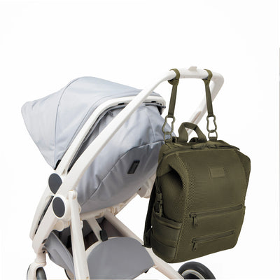 Dagne Dover Large Indi Diaper Backpack in dark green air mesh attached to a stroller.