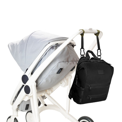 Dagne Dover Medium Indi Diaper Backpack in black air mesh attached to a stroller.