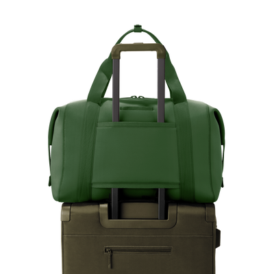 Dagne Dover extra large Landon Carryall in a rich, classic forest green displaying luggage sleeve.