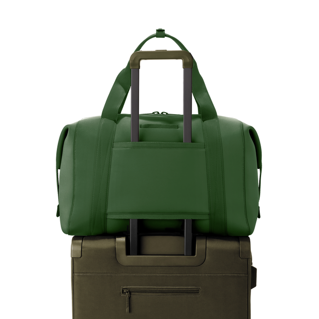 Dagne Dover extra large Landon Carryall in a rich, classic forest green displaying luggage sleeve.