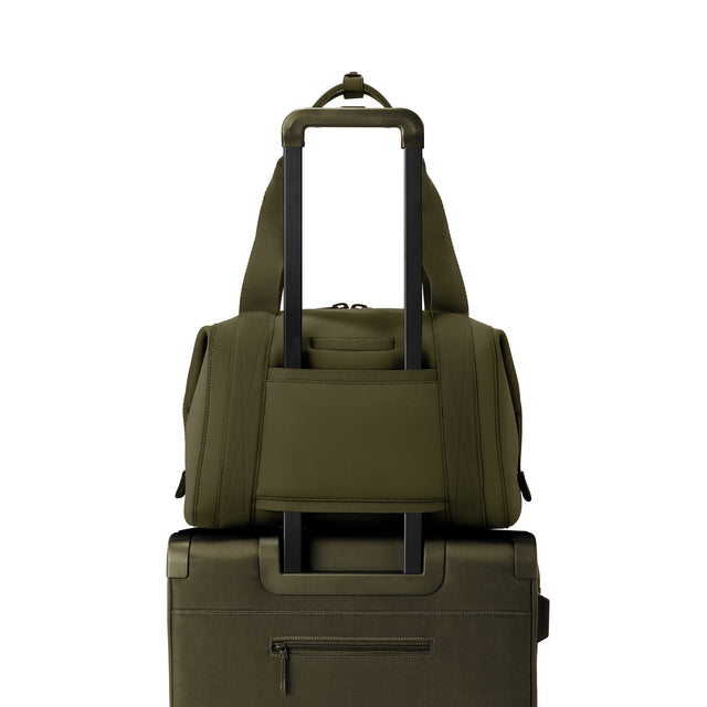 Medium Landon Carryall in dark green displaying luggage sleeve