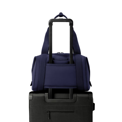 Medium Landon Carryall in  navy blue displaying luggage sleeve