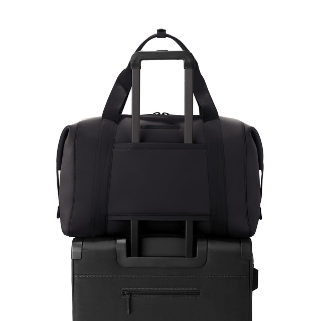 Extra Large Landon Carryall in black displaying luggage sleeve