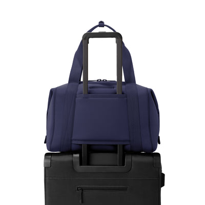 Landon Carryall in  navy blue displaying luggage sleeve