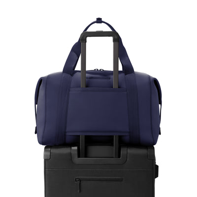 Extra Large Landon Carryall in  navy blue displaying luggage sleeve