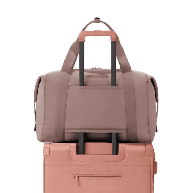 Extra Large Landon Carryall in pink displaying luggage sleeve