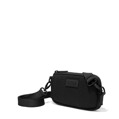 Dagne Dover Mara Phone Sling in black air mesh seen from an angle, showing the adjustable shoulder strap drop.