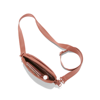 Dagne Dover Mara Phone Sling unzipped in warm dust pink air mesh seen from above, exposing the interior card slots.