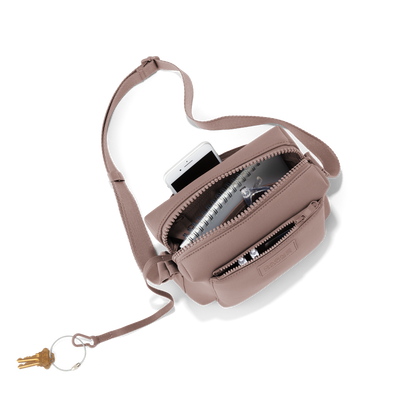 hover - Dagne Dover Micah Crossbody in pink seen from above, showing the interior air mesh pocket.