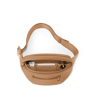 Dagne Dover Ace Fanny Pack in camel brown unzipped, exposing the interior pockets