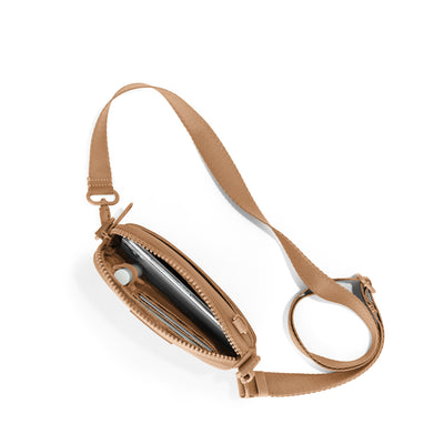 Dagne Dover Mara Phone Sling unzipped in camel brown seen from above, exposing the interior card slots.