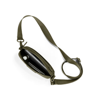 Dagne Dover Mara Phone Sling unzipped in dark green seen from above, exposing the interior card slots.