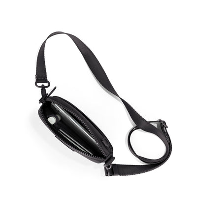 Dagne Dover Mara Phone Sling unzipped in black seen from above, exposing the interior card slots.