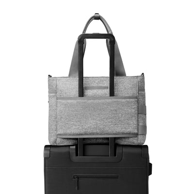 Dagne Dover large Wade Diaper Tote in grey with the neoprene luggage sleeve attached to a suitcase handle.