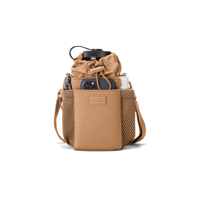 Dagne Dover Sloan Water Bottle Sling in camel brown containing a water bottle and accessories.