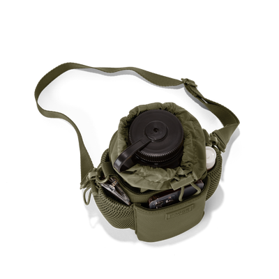 Dagne Dover Sloan Water Bottle Sling in a deep olive green seen from above containing a water bottle and accessories hover