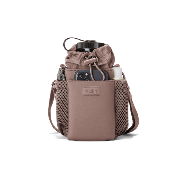 Dagne Dover Sloan Water Bottle Sling in a muted mauve containing a water bottle and accessories.