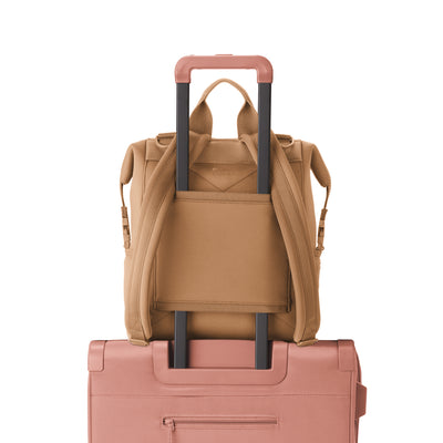 Dagne Dover Medium Indi Diaper Backpack in camel brown showing the neoprene luggage sleeve.