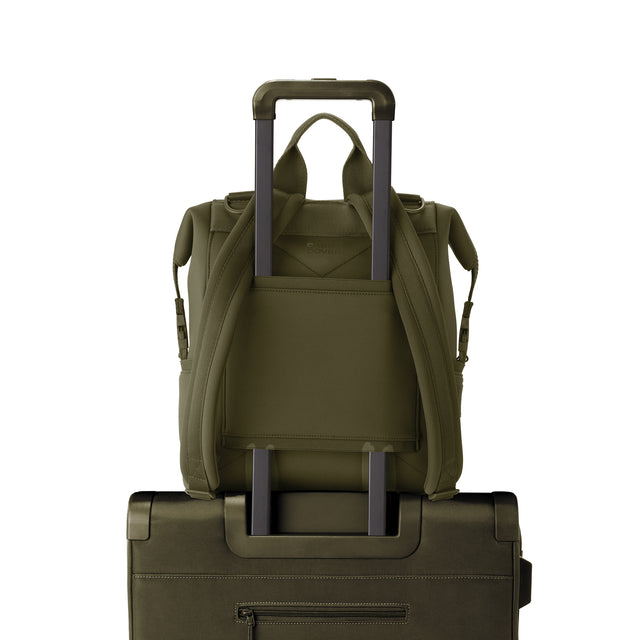 Dagne Dover Medium Indi Diaper Backpack in dark green showing the neoprene luggage sleeve.