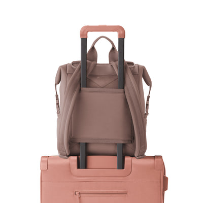 Dagne Dover Medium Indi Diaper Backpack in dune pink showing the neoprene luggage sleeve.