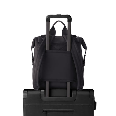 Dagne Dover Medium Indi Diaper Backpack in onyx showing the neoprene luggage sleeve.