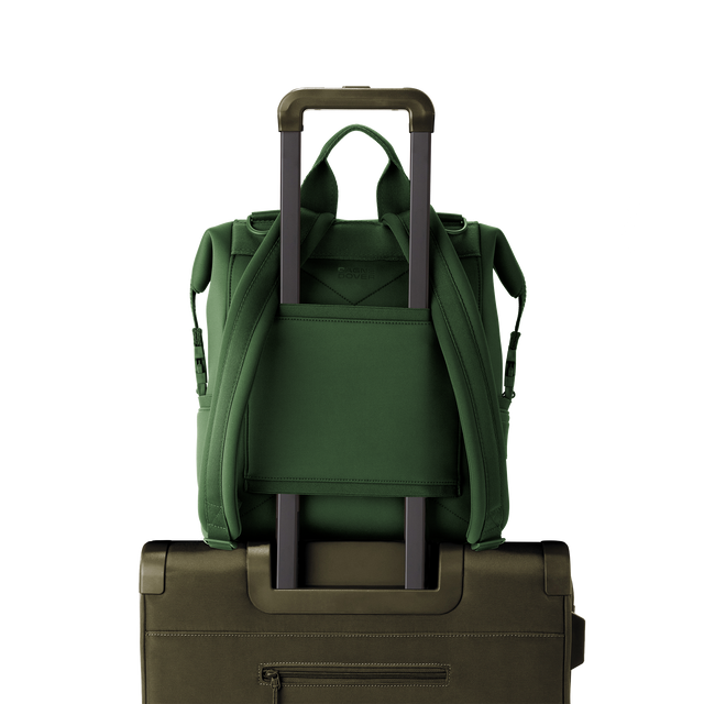 Dagne Dover medium Indi Diaper Backpack in a rich, classic forest green showing the neoprene luggage sleeve.
