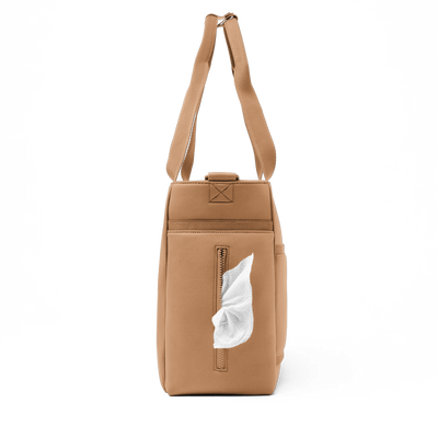 Dagne Dover large Wade Diaper Tote in camel brown seen from the side, with a wet wipe poking out of the slip pocket.