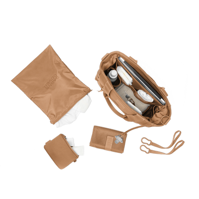 hover - Dagne Dover large Wade Diaper Tote in camel brown from above, alongside the changing mat, neoprene pouch, and water resistant zipper bag.