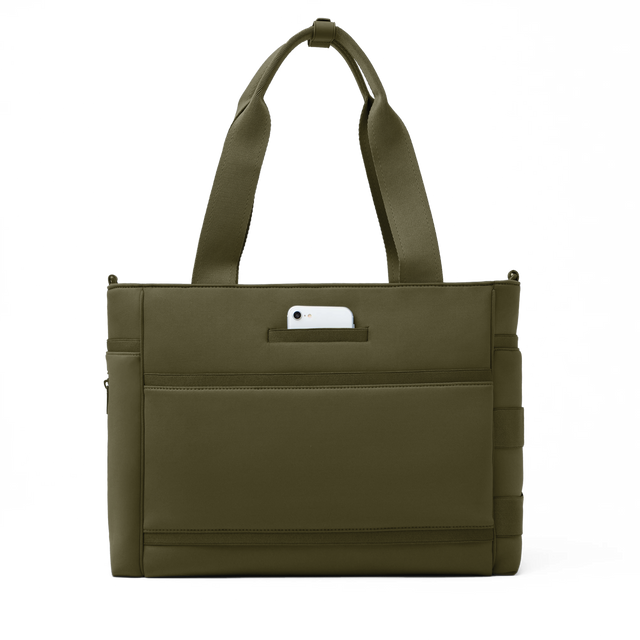 Dagne Dover large Wade Diaper Tote in dark green seen from the back with a phone in the exterior phone pocket.