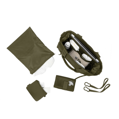 hover - Dagne Dover large Wade Diaper Tote in dark green from above, alongside the changing mat, neoprene pouch, and water resistant zipper bag.