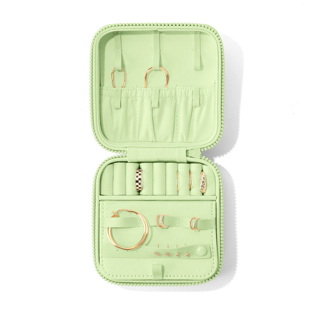 Dagne Dover Large Frankie Jewelry Case in a matcha green, seen open from above with jewelry inside and the interior compartment closed. hover