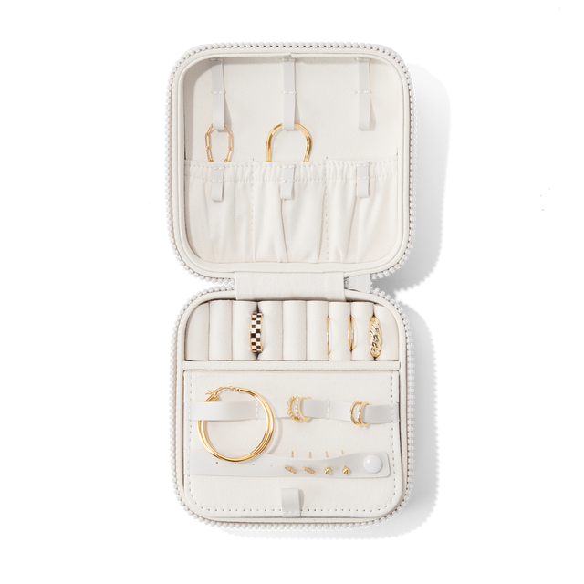 Dagne Dover Large Frankie Jewelry Case in white, seen open from above with jewelry inside and the interior compartment closed. hover