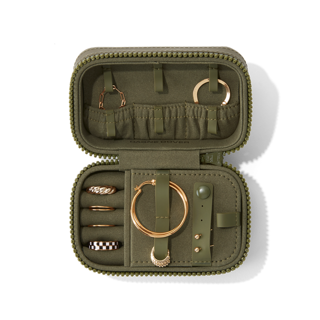 Dagne Dover Small Frankie Jewelry Case in dark green, seen open from above with jewelry inside and the interior compartment closed. hover