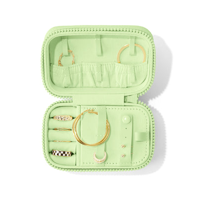 Dagne Dover Small Frankie Jewelry Case in a matcha green, seen open from above with jewelry inside and the interior compartment closed. hover