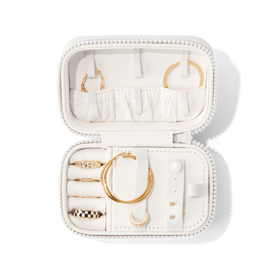 Dagne Dover Small Frankie Jewelry Case in white, seen open from above with jewelry inside and the interior compartment closed. hover