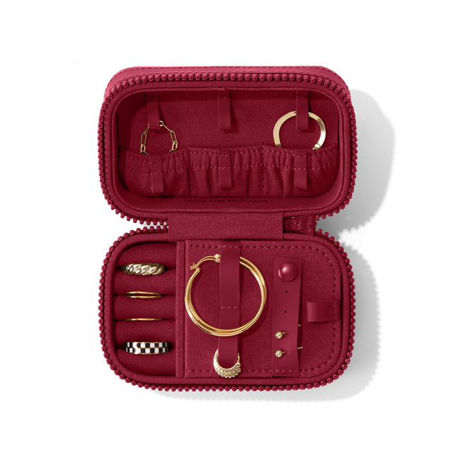 Dagne Dover Small Frankie Jewelry Case in a spice red, seen open from above with jewelry inside and the interior compartment closed. hover