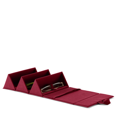 Dagne Dover Remi foldable glasses holder in spice red, unfolded and containing sunglasses.