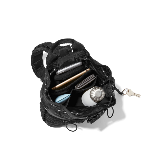 hover - Dagne Dover Nova Sling Bag in black opened, revealing the interior phone pocket and interior airmesh pockets.