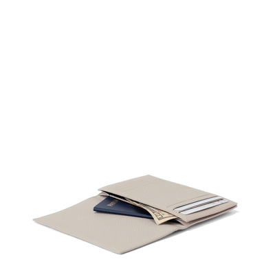 hover - Dagne Dover Accordion Travel Wallet in white opened, revealing the internal card slots and internal gusseted card and passport slots.