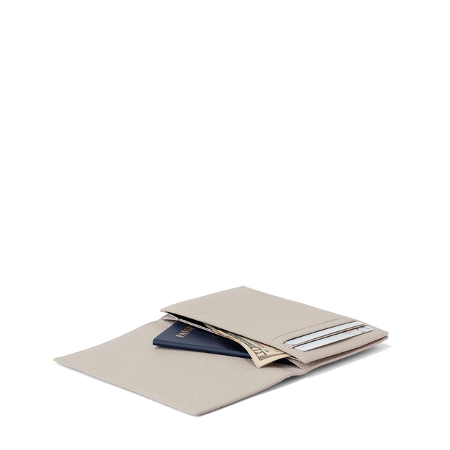 hover - Dagne Dover Accordion Travel Wallet in white opened, revealing the internal card slots and internal gusseted card and passport slots.