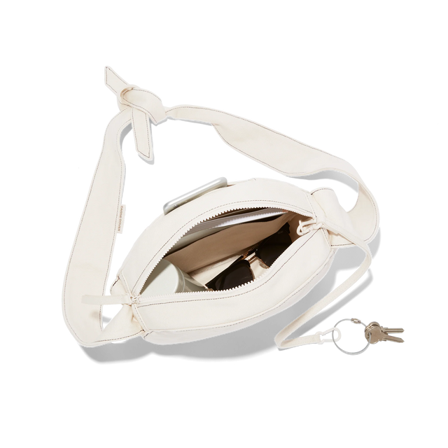 hover - Dagne Dover Luna Shoulder Bag in natural unzipped, revealing the interior slip pocket, interior zip pocket, and hidden magnetic closure.